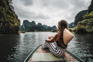 Sticker - A woman on a river boat in Ninh Binh.  Mountains of northern Vietnam.