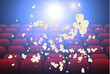 Empty movie theater with projection light falling into the lens and empty seats, popcorn explosion. Vector Illustration