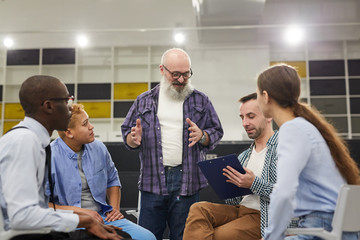 Wall Mural - Portrait of smiling senior man giving speech during therapy session in support group, copy space