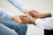 © Seventyfour - Closeup of two people holding hands heartily during therapy se4ssion in support group, copy space