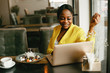 © prostooleh - Elegant black woman. Lady in a yellow jacket. Businesswoman working in a office