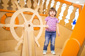 Wall Mural - Little girl on wooden ship playground