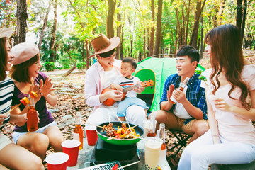 Wall Mural - happy young friends group enjoying picnic party and camping