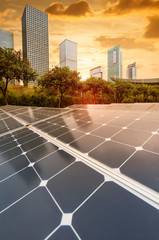 Wall Mural - ecological energy renewable solar panel plant with urban landscape landmarks