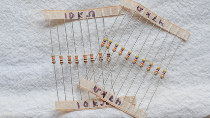 Wall Mural - Packs of electrical resistor components against a white background