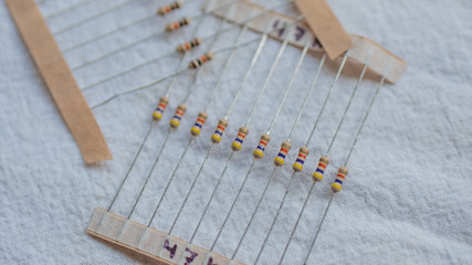 Wall Mural - Packs of electrical resistor components against a white background