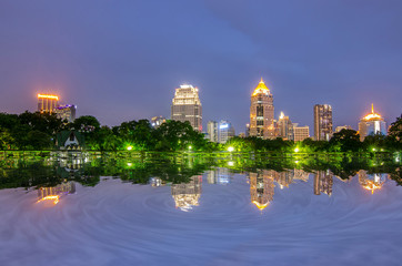 Cityscape at  Modern business area garden at dusk with twilight cloud in Bangkok, Thailand