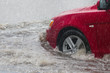 © Shcherbyna - Street in the heavy rain - flood road . red car moving