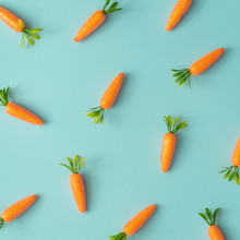 Easter Pattern Made With Carrots On Bright Blue Background. Creative Minimal Holiday Concept. Flat Lay.