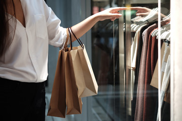 Young woman holding sale shopping bags. consumerism lifestyle concept in the shopping mall