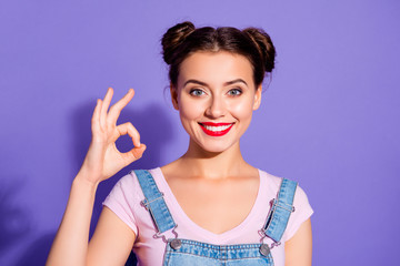 Wall Mural - Close up photo beautiful amazing she her lady buns show white teeth toothy hold arm hand okey symbol perfection wear casual t-shirt jeans denim overalls clothes isolated purple violet background