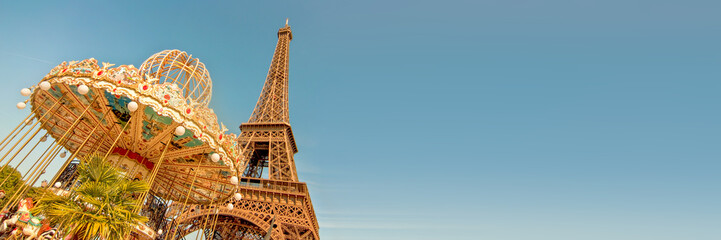 Vintage carousel and the Eiffel tower, Paris France panoramic background with copy space