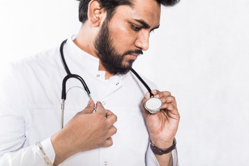 Poster - Handsome young doctor in a white coat with a stethoscope. Health care concept.