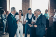 © deagreez - Close up photo morning diversity age mixed race business people stand she her he him his best brigade conversation tell speak listening reading beverage interested curious formal wear jackets shirts