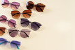 Different sunglasses on yellow background. Summer banner. Copy space. Optic shop