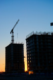 Fototapeta Miasto - construction of the building cranes in the strongest light, otherwise