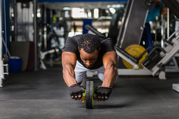 Wall Mural - Black African American  young man doing  workout at the gym