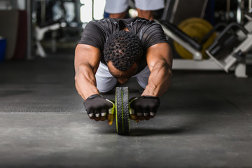 Wall Mural - Black African American  young man doing  workout at the gym