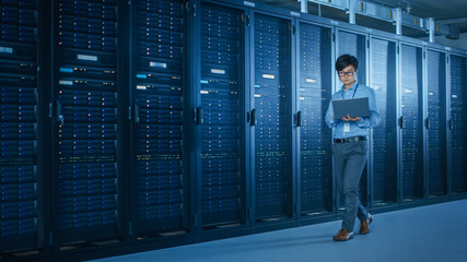 Aufkleber - In the Modern Data Center: IT Engineer Working with Server Racks, Uses Laptop for Maintenance and Diagnostics. Checking Stability of the System