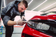 © hedgehog94 - Car detailing - Worker with orbital polisher in auto repair shop.