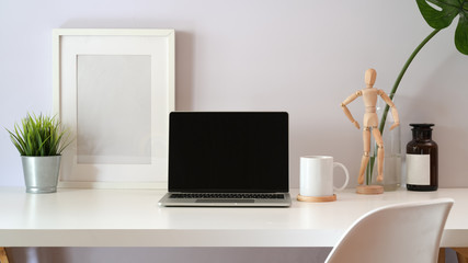 Mock up laptop on loft white workspace