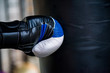 Close up black and boxing glove hitting punching bag