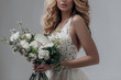 © irinaneva - beautiful sexy blonde bride posing in a sparkling wedding dress with bouquet. advertising space