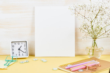 Wall Mural - Mockup with blank white frame on yellow table against wooden wall, alarm, flower in vaze