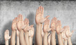 © adam121 - Row of man hands showing voting gesture