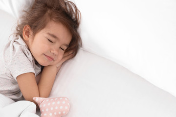 Wall Mural - Cute little girl with toy sleeping in bed