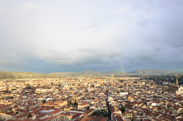 a beautiful cityscape and a rainbow on a cloudy day