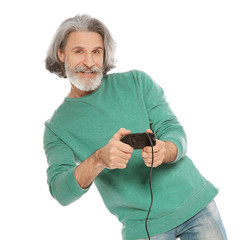 Emotional mature man playing video games with controller isolated on white