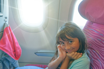 Canvas Print - Happy young girl during a long flight