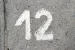 © robot recorder - Parking lot asphalt stencil number 12 street sidewalk