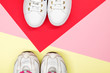 White sneakers on colorful background. Flat lay