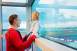 © Tomsickova - Father and child, traveling together, waiting at the airport to board the aircraft