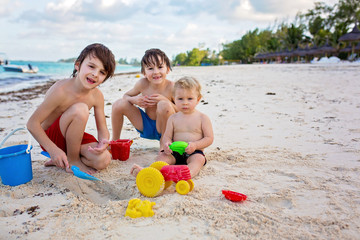 Wall Mural - Cute baby boy playing with beach toys on tropical beach