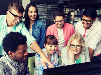 Poster - people, education, technology and school concept - group of happy smiling international students with computers at library in university