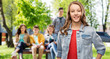 © Syda Productions - teen and people concept - smiling teenage girl with long hair in denim jacket over her friends on summer background