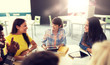 © Syda Productions - education, high school, people and technology concept - group of international students sitting at table with tablet pc computers, books and notebooks talking at university