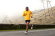 © mimagephotos - Full length side of healthy young african american man running on street