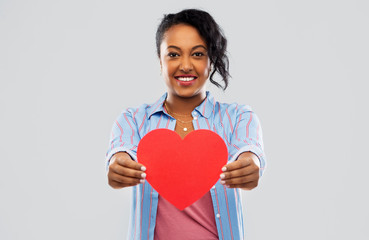 Sticker - love, valentine's day and charity concept - happy african american young woman with red heart over grey background