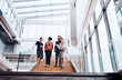 © Halfpoint - Group of young businesspeople walking down the stairs, talking.