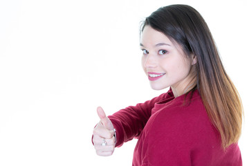 Wall Mural - Portrait of lovely brunette woman 20s smiling and showing thumbs up isolated over white background