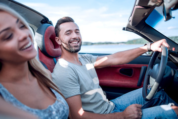 close up.the couple sitting in a convertible car.