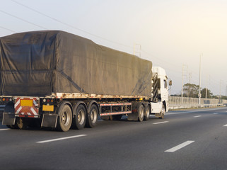 White Truck on highway road with  container, transportation concept.,import,export logistic industrial Transporting Land transport on the asphalt expressway