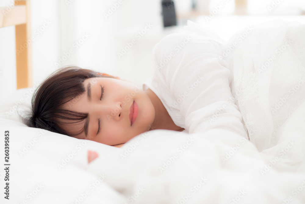 Beautiful asian young woman sleeping lying in bed with head on pillow comfortable and happy. girl with relax for health concept. - obrazy, fototapety, plakaty 