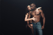 © LIGHTFIELD STUDIOS - beautiful sexy woman passionately hugging shirtless african american man isolated on black with copy space