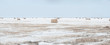 © vadim yerofeyev - Snow covered round bale of hay in a farmers field