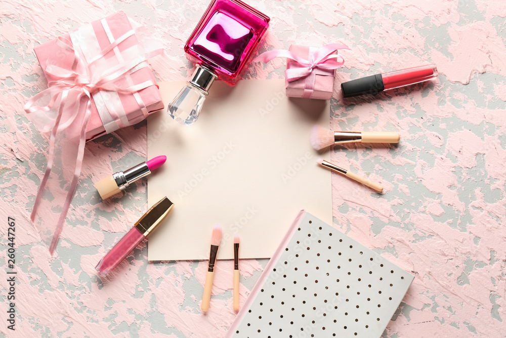 Empty sheet of paper with gift boxes and makeup cosmetics on color background